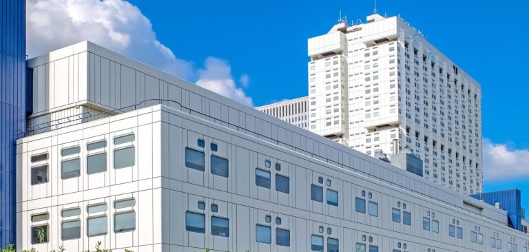 Exterior shot of a white hospital building.
